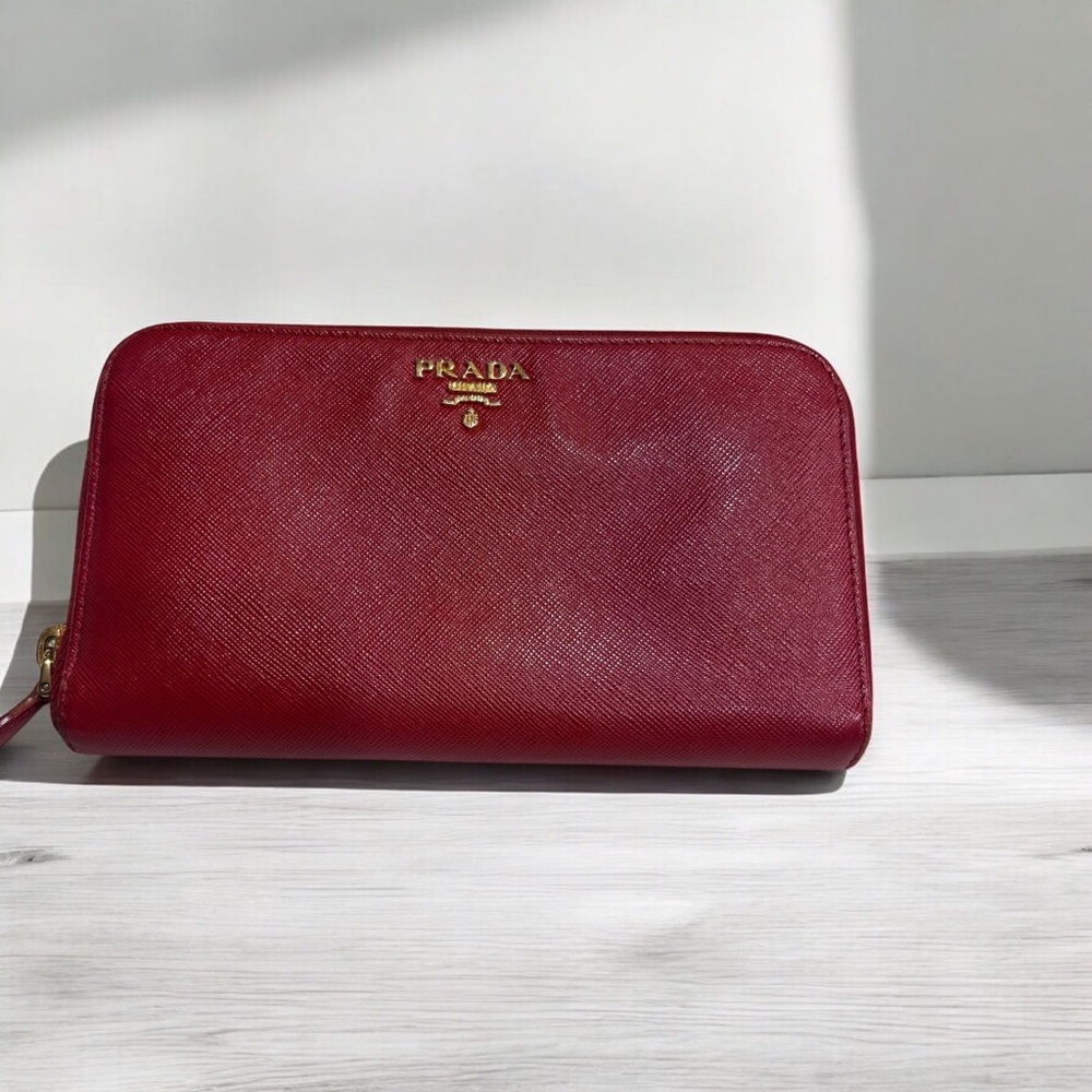 Prada long zip around red saffiano leather wallet.